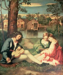 Jugendlicher mit Gitarre und zwei Mädchen am Flussufer